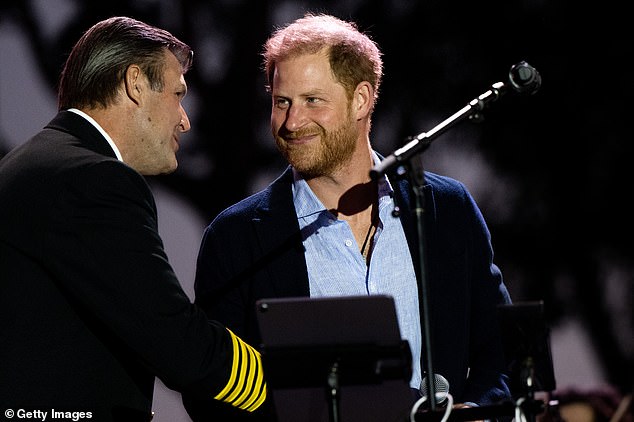 Prince Harry presents an award to the Santa Barbara Fire Department during the One805Live Fall Concert in Carpinteria