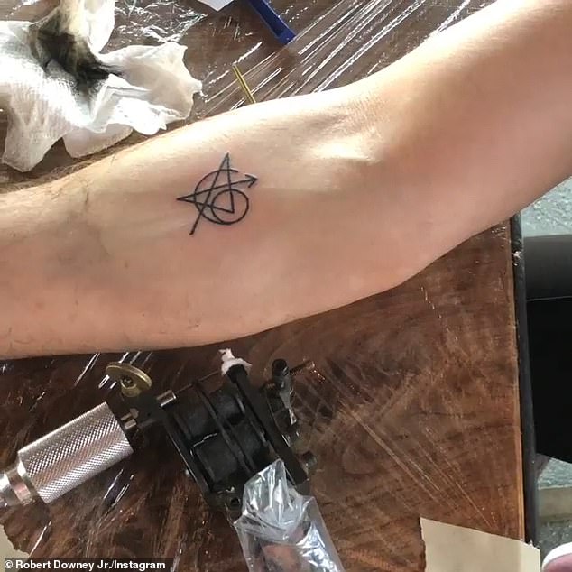 'There's a symbol for everybody in the movie hidden in there. Their initials are also all hidden in there,' Lord said of the Avengers castmates' matching tattoos (pictured)