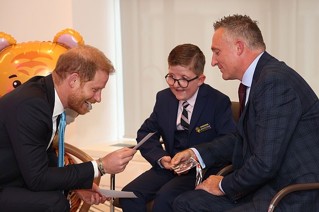 Lewis Connett, 11, meets Prince Harry at the event on Monday