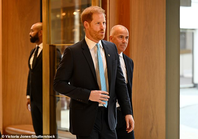 Harry and his bodyguard arrive at the Royal Lancaster Hotel this afternoon