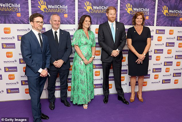 Prince Harry, Duke of Sussex (second right) smiles as he poses with dignitaries at the Wellchild Awards 2024 at the Royal Lancaster Hotel