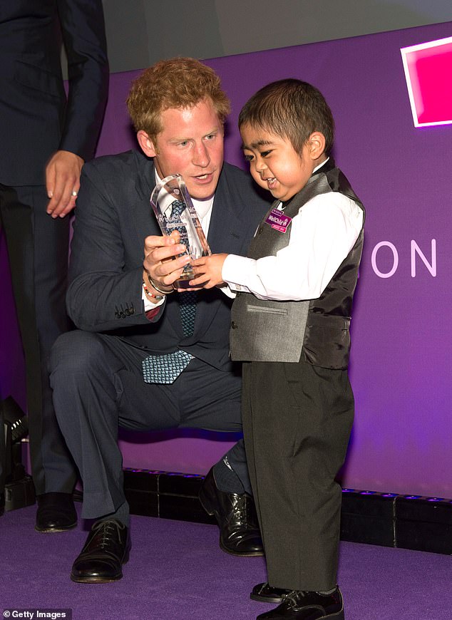 Harry presenting an award to youngster Jonathan He during the ceremony in 2013