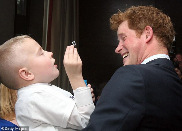 Harry smiling at six-year-old Alex Burke, who was winner of the Bravest Child Award in 2009