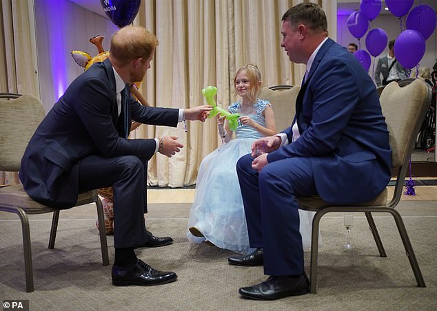 Harry speaking to Poppy and her father Daniel Higham during the awards last year