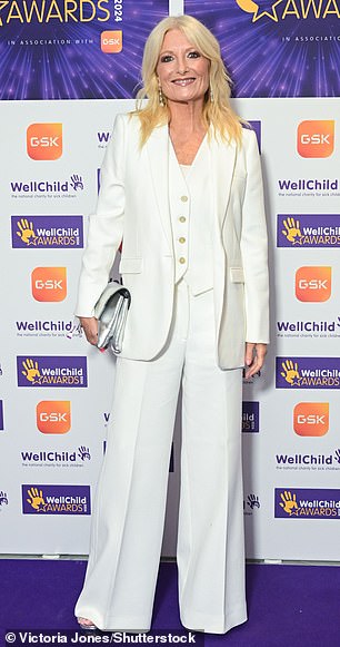 Gabby Roslin looked effortlessly stylish in a white three-piece suit while toting her essentials in a silver clutch