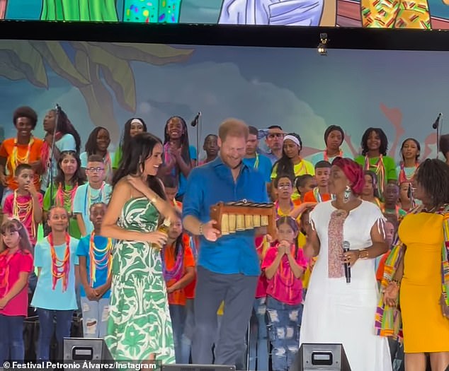 The Duke, 39, and Duchess, 43, of Sussex were cheered on my a crowd during their Colombian tour as Harry was gifted a musical instrument