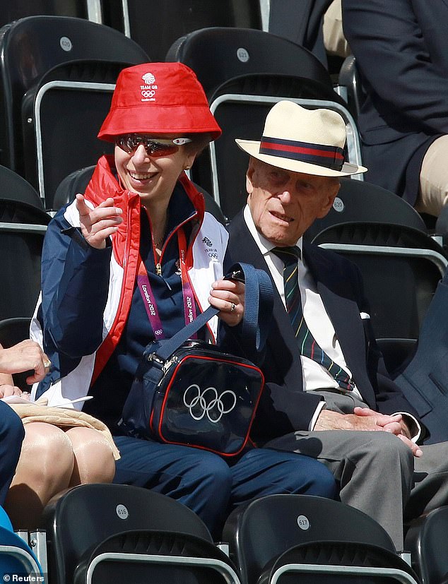 Princess Anne wearing Adidas Team GB shades as she sits with her father Prince Philip to watch her daughter Zara compete at the 2012 London Olympics