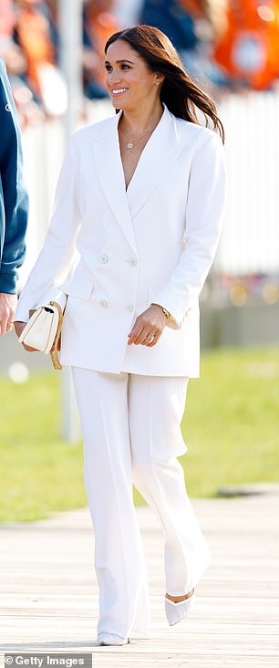 At the 2022 Invictus Games, Meghan sported a white suit by Valentino, consisting of an oversized double-breasted blazer and wide-leg trousers