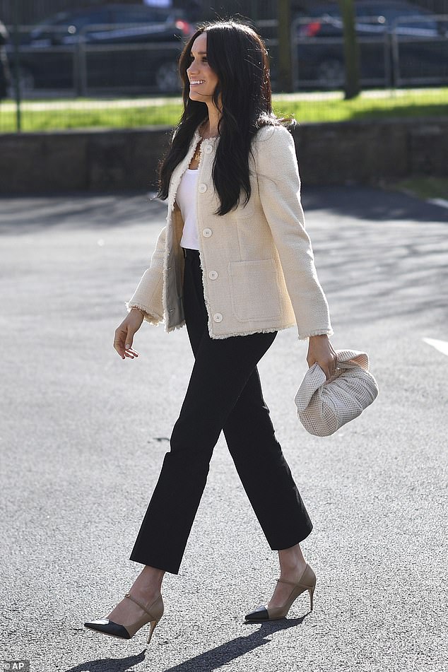 One of the the Duchess of Sussex's most iconic outfits saw her wearing these Jennifer Chamandi two-tone £550 Lorenzo heels for a visit to Robert Clack Upper School in Dagenham, Essex, on International Women's Day in March 2020