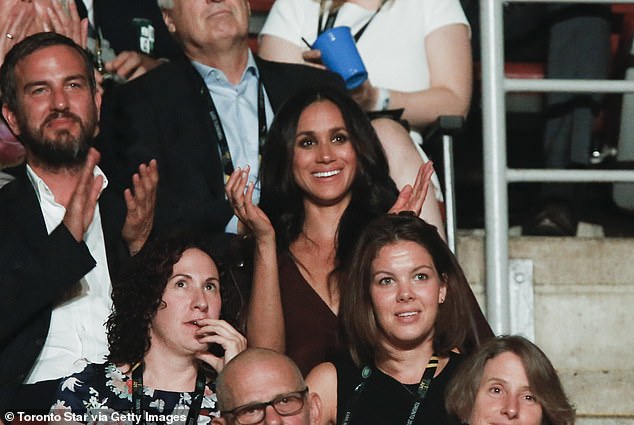 Meghan attending the day before and sitting with her close friend, Markus Anderson