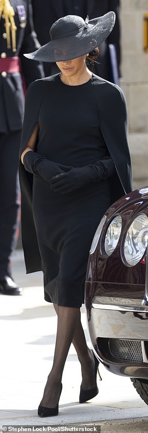 Meghan, Duchess of Sussex, opted for a Stella McCartney cape dress, paired with a curvaceous hat by Stephen Jones