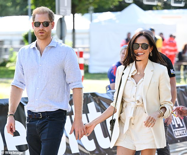 Harry and Meghan attend the cycling medal ceremony at the Cycling Track during day six of the Invictus Games last year