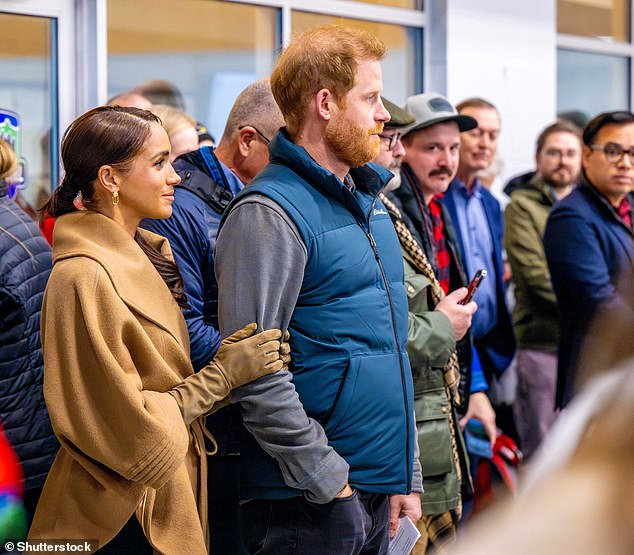 Meghan holding Harry's arm at an Invictus Games event in February