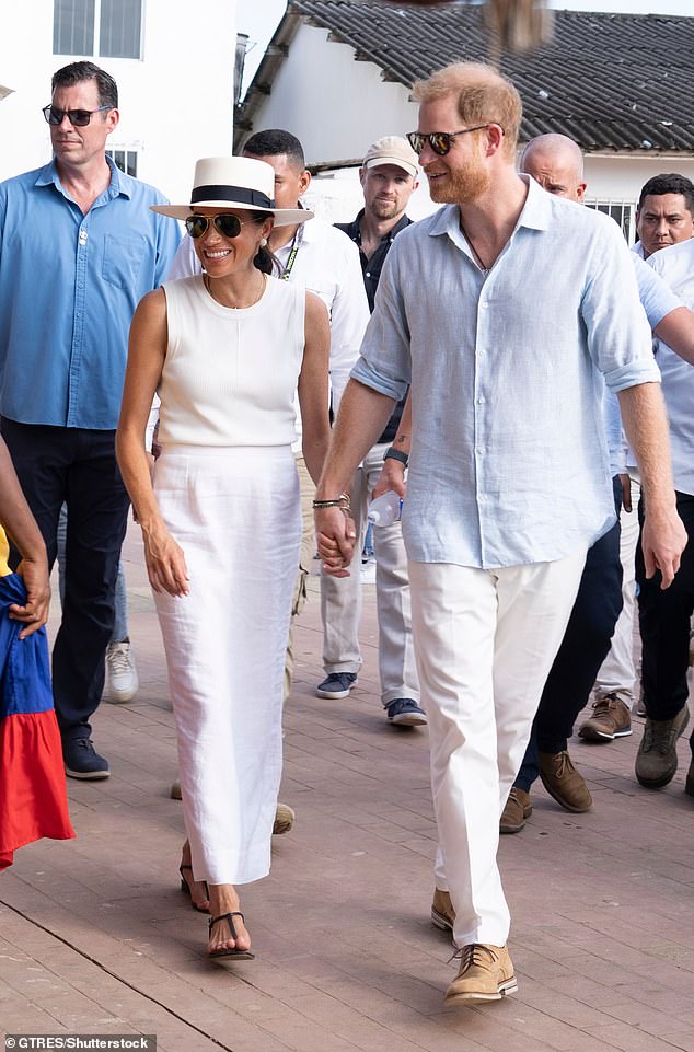 The couple holding hands and smiling during their trip to Colombia in August