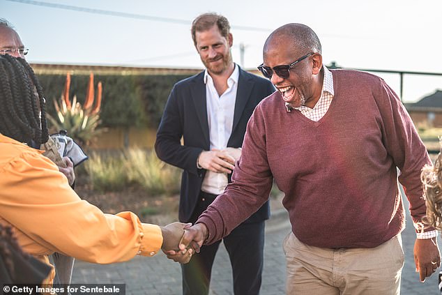 Prince Harry smiles next to Prince Seeiso of Lesotho for the welcome event for his charity