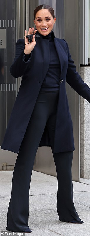 In 2021, Meghan embraced tonal dressing with a navy ensemble, featuring a Giuliva Heritage roll neck jumper and Emporio Armani flared trousers