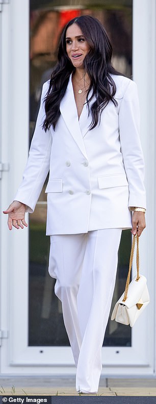 At the 2022 Invictus Games, Meghan sported a white two-piece by Valentino, comprising an oversized double-breasted blazer and wide-leg trousers