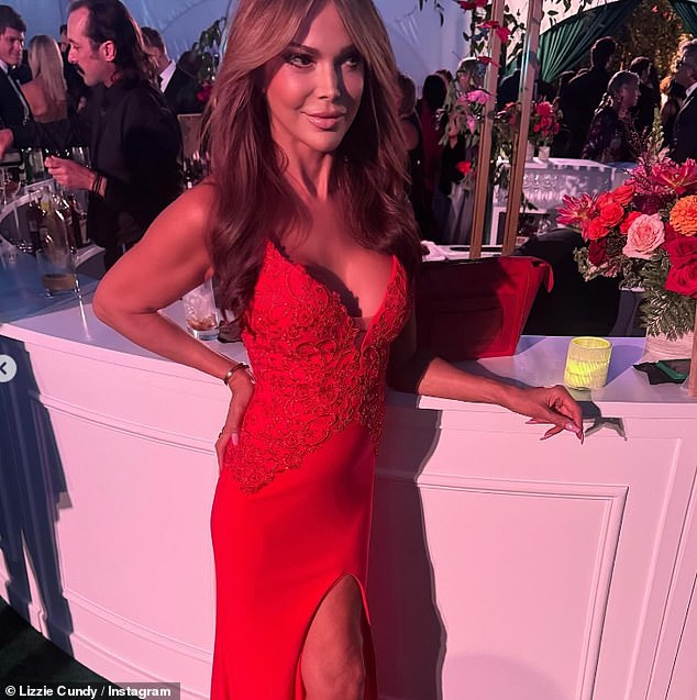 Lizzie looked sensational at the event as she showcased her ample cleavage in a low cut red dress