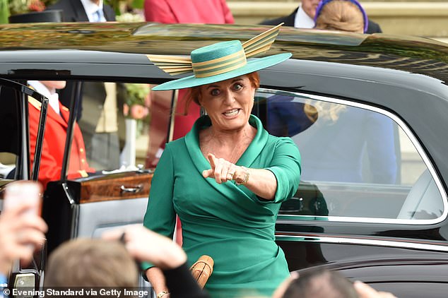 The bride's mother, Sarah Ferguson, spots people she knows as she arrives at the wedding