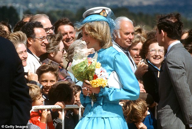 Holding flowers, Diana talks to well-wishers with Charles as they arrive at RAAF base Fairbairn in Canberra, Australia