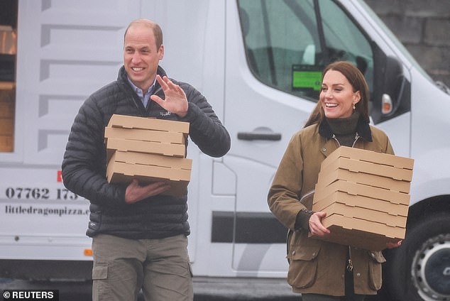 William and Kate carrying pizza boxes during a visit to Dowlais Rugby Club last year