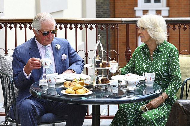 The King and Queen enjoying an afternoon tea during a visit to a theatre in London in 2021