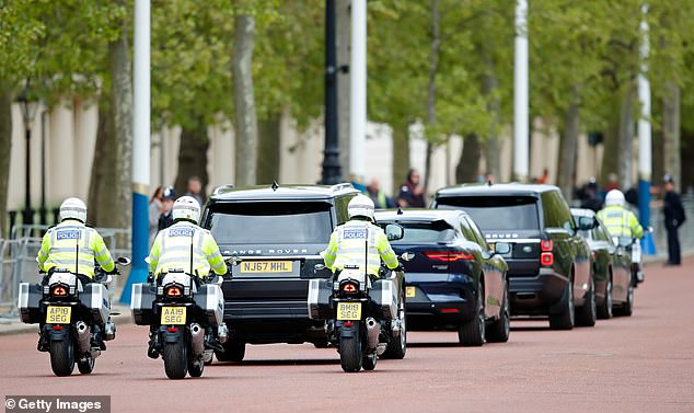 Pictured are officers protecting a convoy carrying King Charles, the Princess of Wales and Queen Camilla back in May 2021