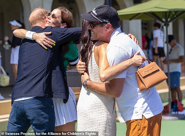 In August, Meghan was also seen sharing hugs with Kelly and her husband Julian at the George Zajfen Tennis Tournament