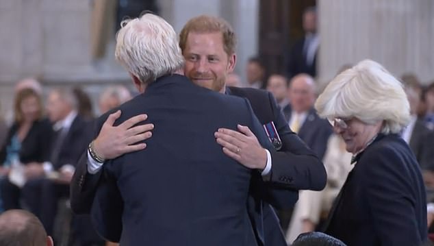 Prince Harry hugging his uncle, Charles Earl Spencer, while his aunt Lady Jane Fellowes stands nearby at the tenth anniversary of the Invictus Games in May