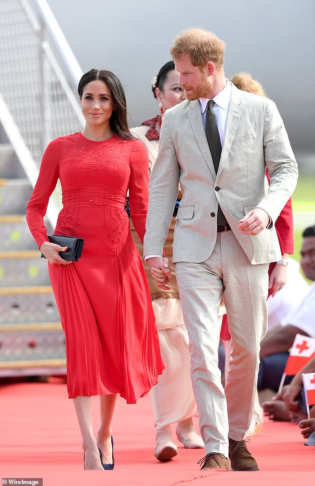 Meghan turned heads when she arrived with Prince Harry in Tonga in October 2018, wearing a demure £380 dress by Self-Portrait