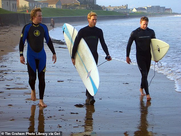 Prince William, 22, walking along the beach in St Andrews with two friends in 2004