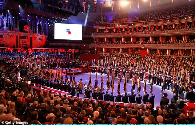 2018: A large procession salutes in the arena during the Festival of Remembrance at the Royal Albert Hall, as members of the royal family watch on