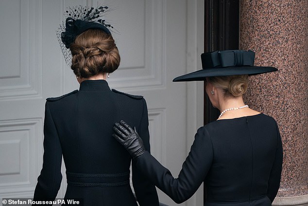 Following the two minute silence, the Duchess of Edinburgh placed a supportive hand on the Princess of Wales' back as they left the balcony