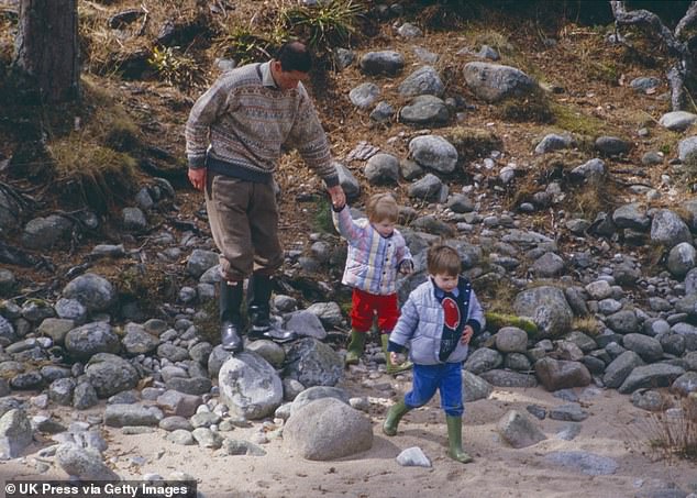 Charles, William, and Harry play on the bank of the River Dee, near Balmoral Estate, Scotland, on April 10, 1987