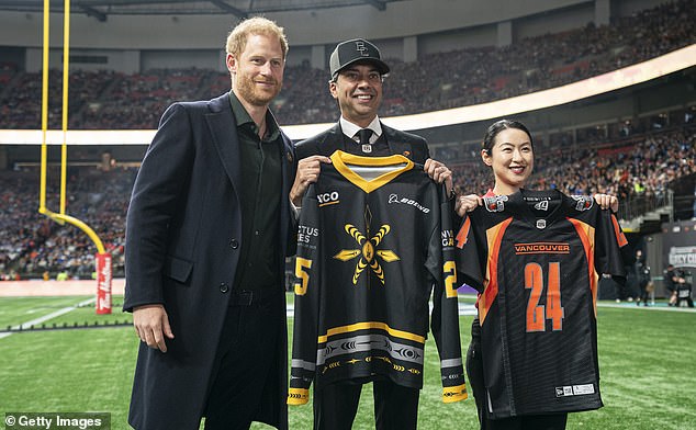 Prince Harry, Amar Doman, owner of the BC Lions, and Wenshuang Nie, a competitor in the Invictus Games, pose for a photo prior to the start of the 2024 Grey Cup