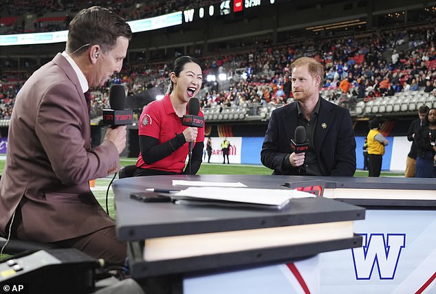 Harry looks on as Team Canada Invictus Games athlete Wenshuang Nie laughs