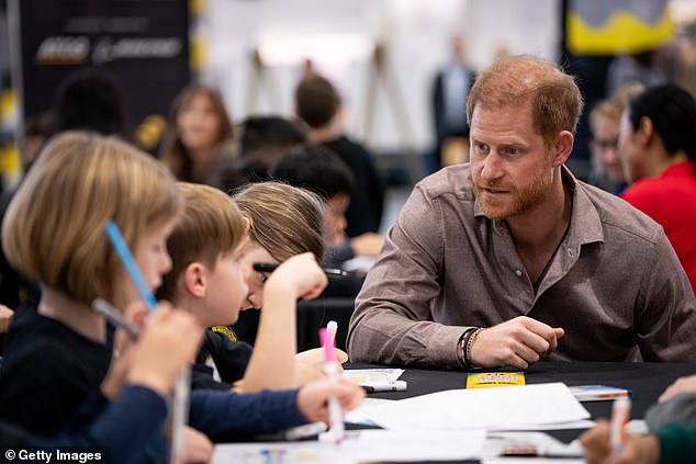 Prince Harry appeared deep in discussion with school children, as he spoke to them about the power of sport