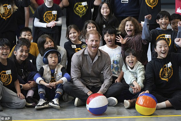 Prince Harry posed for photos with students from Shaughnessy Elementary School after taking part in a sitting volleyball adaptive sport lesson