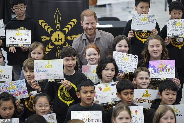 Say cheese! The Duke poses for a photograph with students from Shaughnessy Elementary School