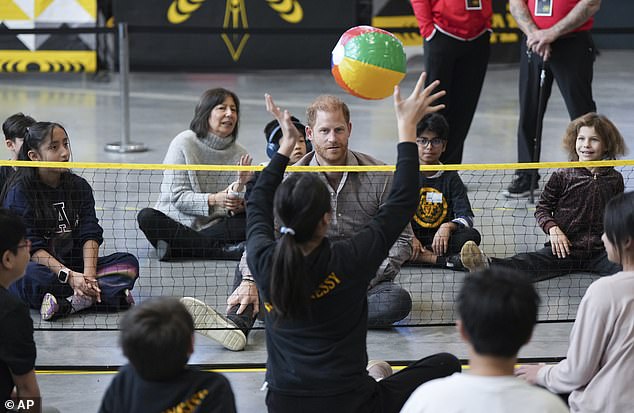 Wait for it! Prince Harry keeps his eye on the ball as he participates in a sitting volleyball adaptive sport lesson