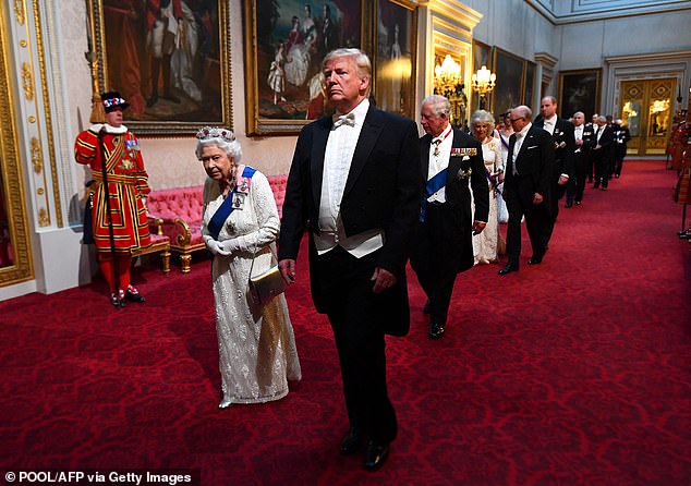 Queen Elizabeth II walks with Donald Trump at Buckingham Palace for the banquet in 2019