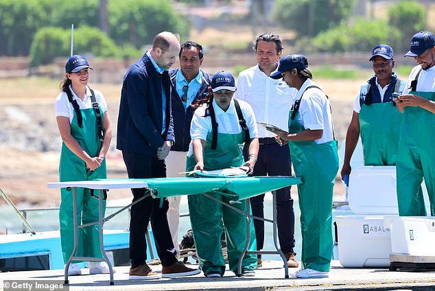 The Prince of Wales watched on intently as he was shown the ropes by one of the workers on the harbour