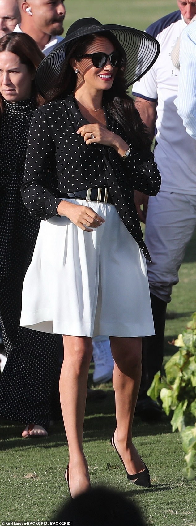 Meghan Markle sported a chic Celine polka dot tie-neck blouse, which she paired with voluminous Khaite shorts and Aquazzura heels