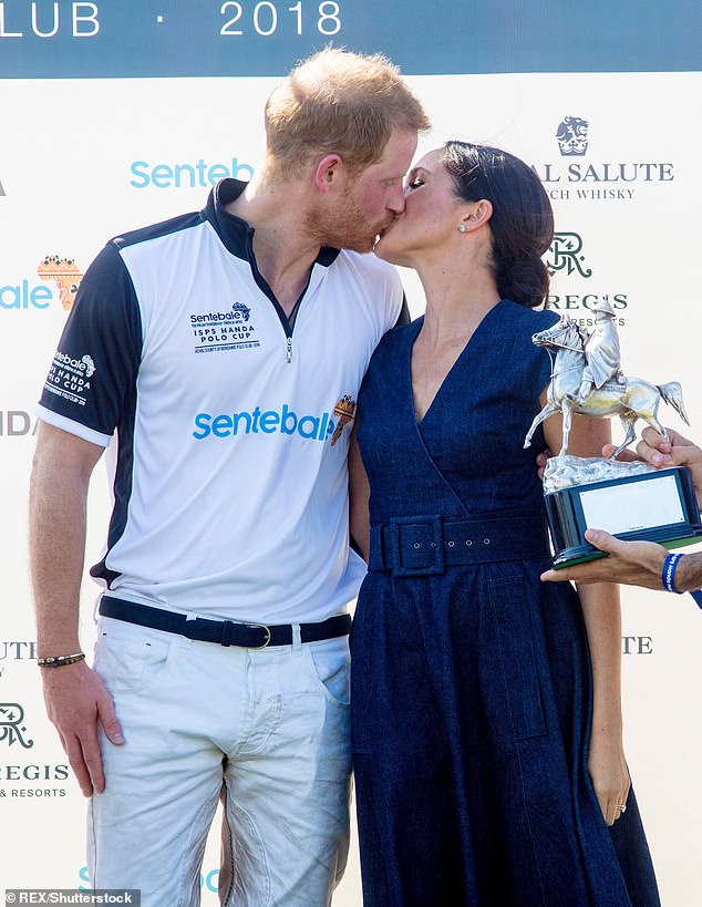 Harry and Meghan share a kiss after the prince won a charity match in 2018