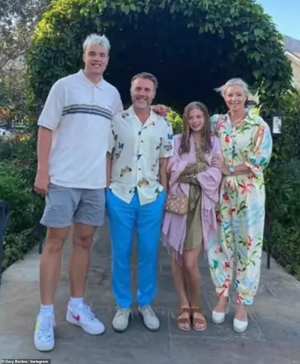 Gary Barlow shares Daniel, 25 (L) Emily, 22 and Daisy, 15 (R) with wife of 25-years Dawn Andrews (far right). The photo has gone viral after a sweet family photo showed his son towering over him, but some are shocked by his real height