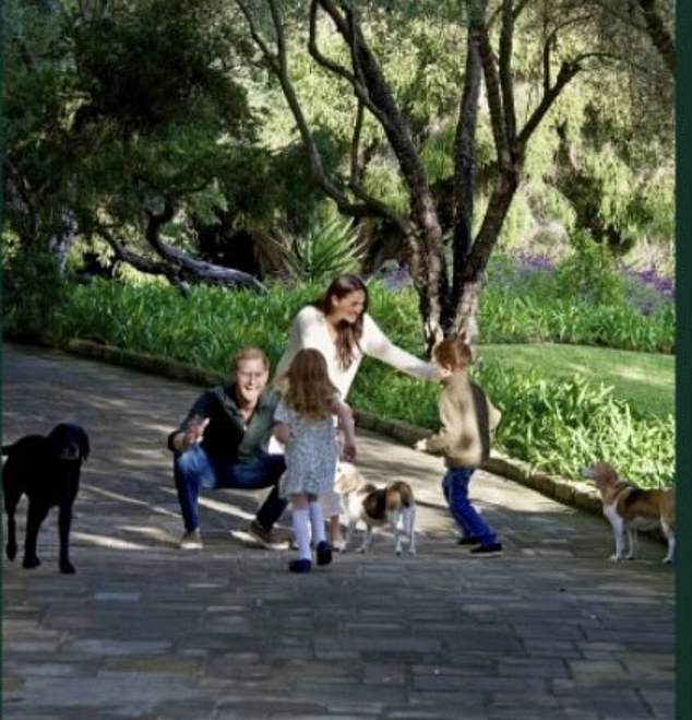 The close-up of the family photo of the Sussexes shows the doting parents greeting their children - Prince Archie and Princess Lilibet - with open arms