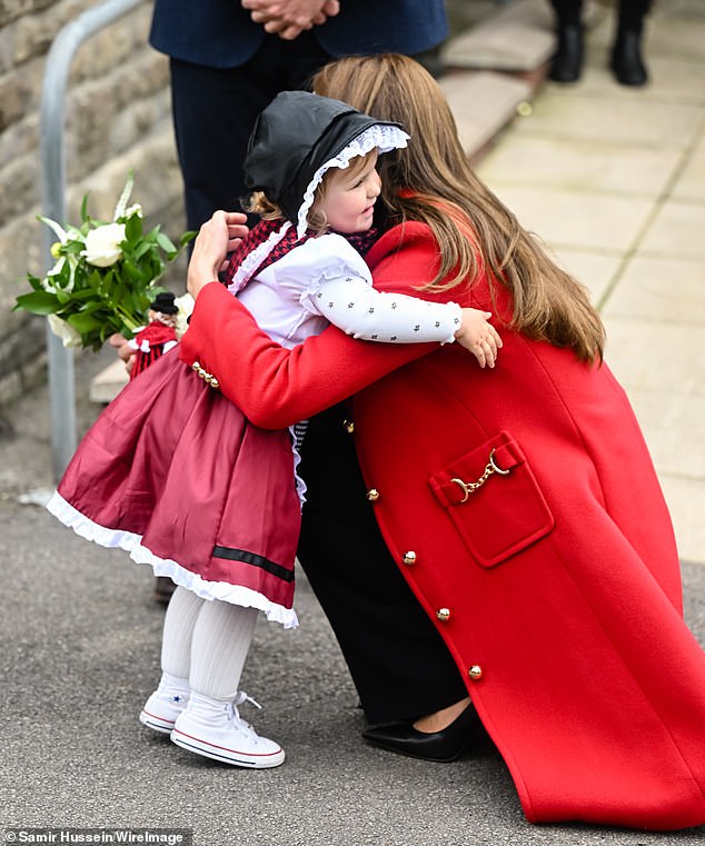 The warmth that radiates from the Sussexes' holiday card is reminiscent of embraces shown by the Princess of Wales on some occasions. Pictured in Wales, 2022, hugging two-year-old Charlotte Bunting