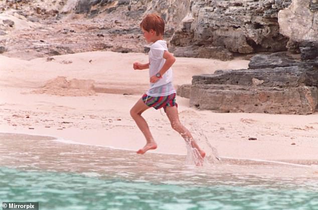 Prince Harry is pictured running across a sandy beach in the Bahamas in 1993