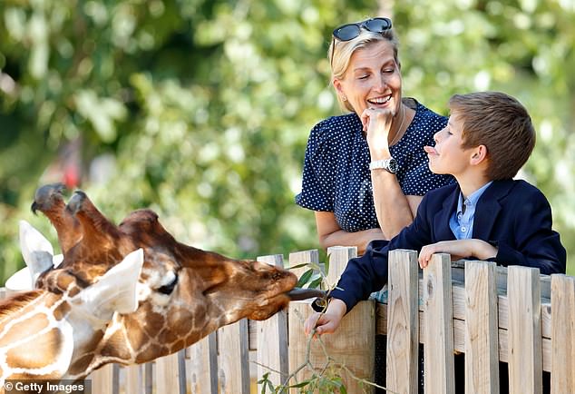 James feeding a giraffe with his mother, Sophie, at Bristol Zoo in 2019