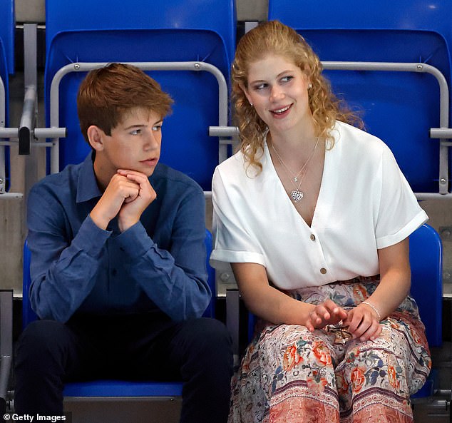 James watching the swimming with his older sister during the Commonwealth Games in 2022